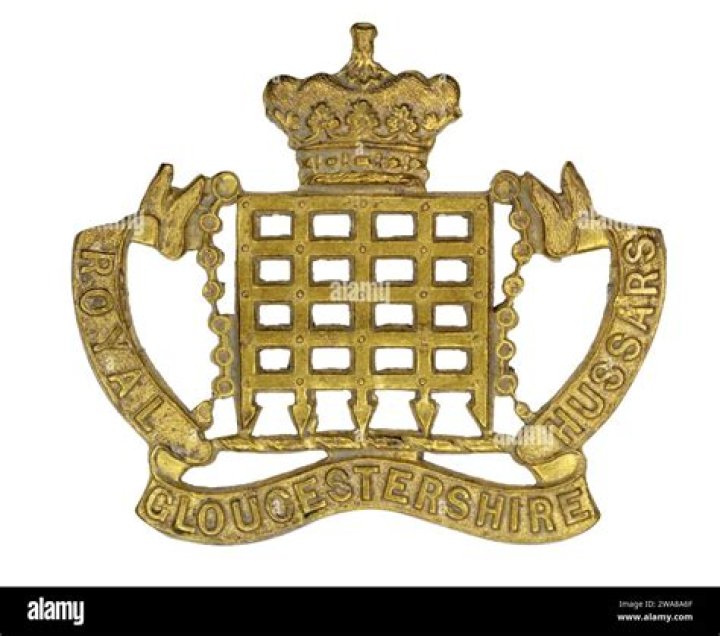 Why does the Gloucester Regiment wear two cap badges?